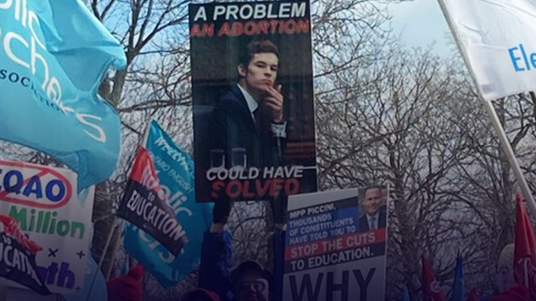 Sign spotted at teachers’ protest saying Ontario PC MPP should have been aborted
