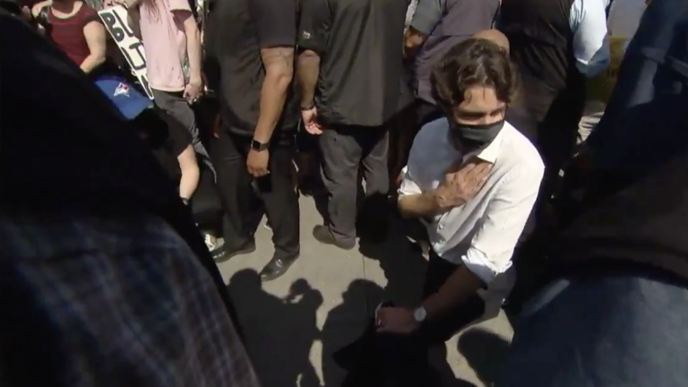 Trudeau gets heckled, kneels before protesters