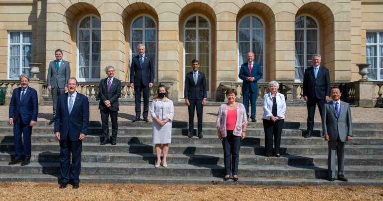 Freeland caught putting on mask for photoshoot with world leaders